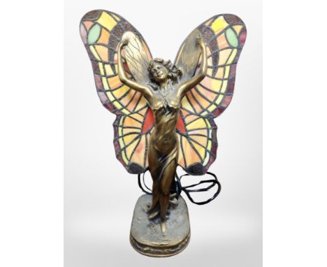 A contemporary Tiffany-style resin and glass table lamp modelled as a lady with outstretched butterfly wings, height 40cm.