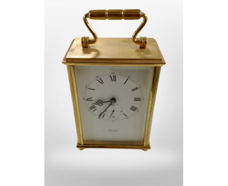 A brass-cased 8-day mantel timepiece signed Imhof, height 15cm including handle.