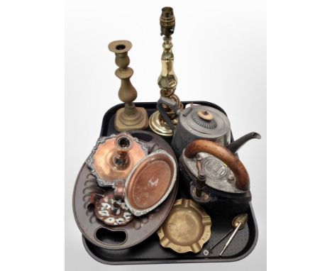 A group of metal wares including a 19th century pewter teapot, brass candlestick and lamp base, iron, chamber sticks.