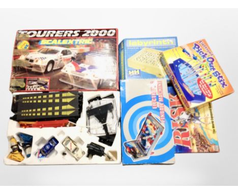 A box containing Scalextric racing set and other board games, pinball machine.