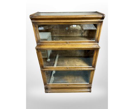 A Globe-Wernicke glazed oak three tier stacking bookcase, 86 cm x 37 cm x 137 cm 