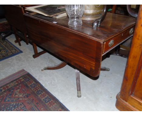 A 19th Century Mahogany & Crossbanded Sofa Table with turned column and four splayed legs with brass paw toe castors. €100-20
