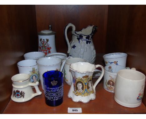 A Shelf of Commemorative Beakers, Mugs and Tankards to include painted blue glass 1897 Victoria Jubilee.
