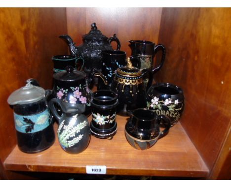 A Shelf of Black Victorian Jetware Teapots and Jugs, together with a small black Shelly jug painted and enamelled. €60-80