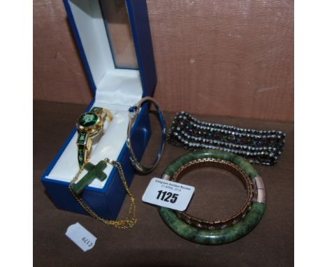 A Ladies Wristwatch, with hinged covered face, a green hardstone bangle and cross and three further bracelets. €30-40