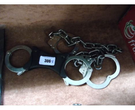Two Pairs of Handcuffs, along with a rubber Police Baton (3).