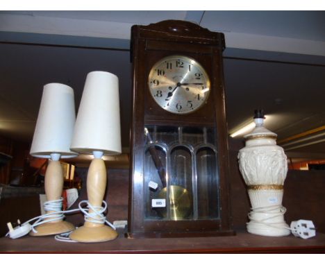 A Gustav Becker Wall Clock, Pair of Timber Table Lamps, and another table lamp with relief figural decoration. (4) €40-60