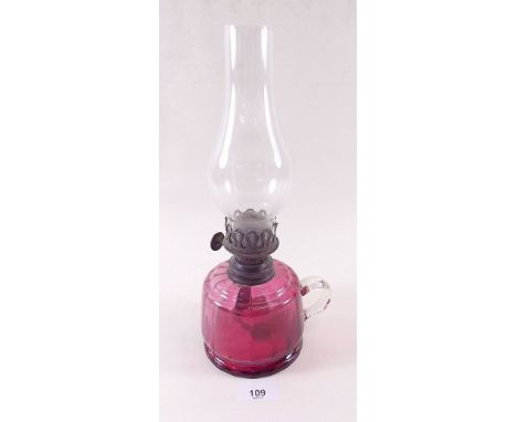 A Victorian cranberry glass oil lamp 