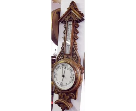 A Victorian carved oak aneroid barometer 