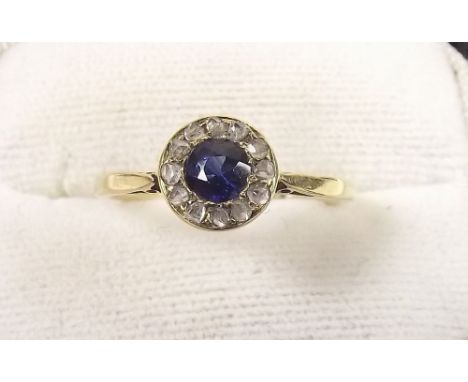 An Edwardian 18ct gold sapphire ring with diamond surround.