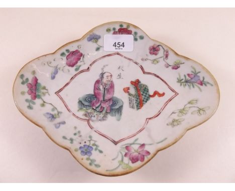 A late 19th century Chinese famille rose lobed dish depicting scholar seated on a tree trunk, 23 x 18cm