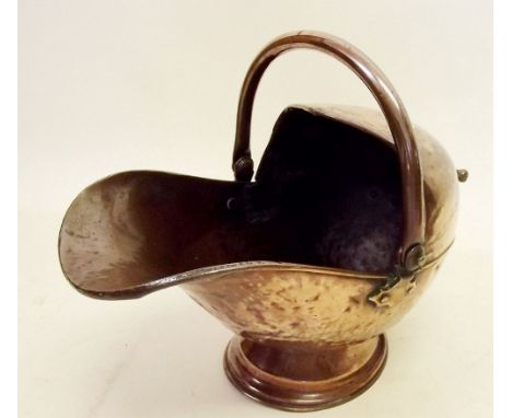 A Victorian copper helmet form coal scuttle 