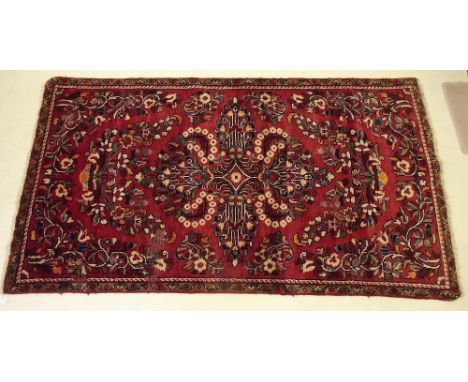 A Persian village rug with red ground 196 x 109cm