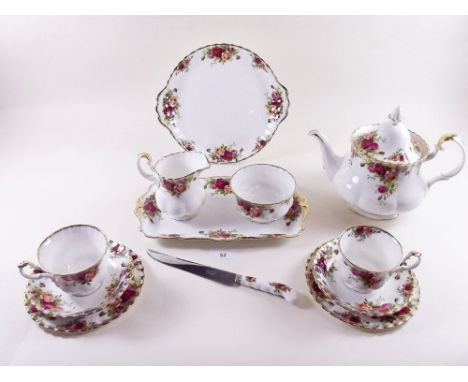 A Royal Albert Country Roses teaset comprising: teapot, six cups and saucers, milk, sugar, cake plate, six teaplates, sandwic