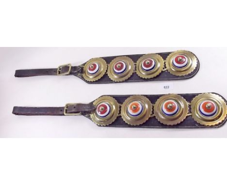 A pair of brass and ceramic horse brasses 