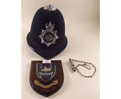 A policeman's helmet, whistle and plaque