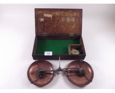 A set of 19th century balance scales and a set of brass weights in oak case