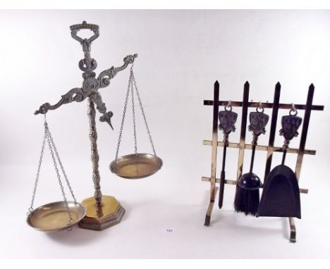 A brass set of scales and a fireside set