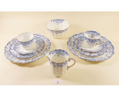 An Edwardian blue floral teaset by Tuscan China comprising: ten cups and saucers, twelve tea plates, cake plate, jug and suga