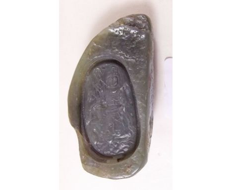 A Chinese green jade stone carved inset intaglio of a deity 