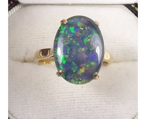 A gold ring set oval opal doublet 