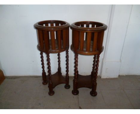 A pair of 20th century mahogany basket planters, on barley-sugar twist supports to bun feet, with shelf stretcher 83.5 cm H 