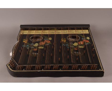 A Harpeleik Zither, steel strings and dual floral decoration to the sound board, with scale listing to base. 