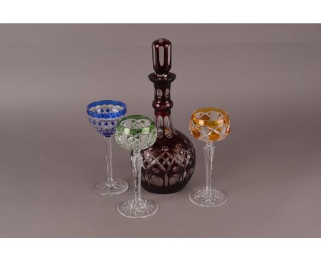 A bohemian cut and red flashed glass decanter, together with a group of five cut and flashed glass wine glasses and a set of 