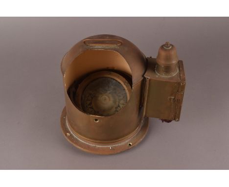 A vintage brass housed ships compass, the domed housing having applied oil lamp mount, the interior painted white, and having