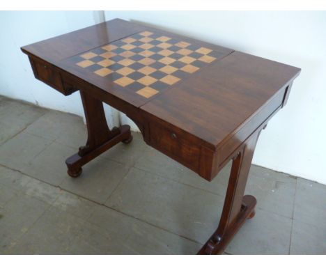 A William IV style games table by Burr & Son of Bedford, the central panel flips to become a chess board and encloses a backg