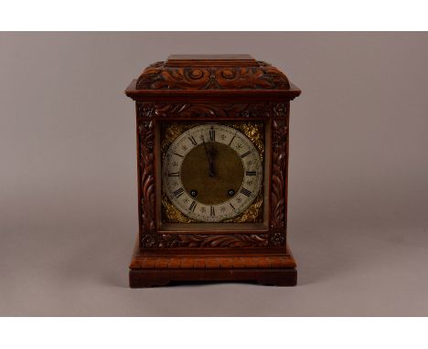 A Late Victorian Oak cased mantle clock, with carved leaf decoration, eight day movement by   Lenzkirch, striking on twin coi