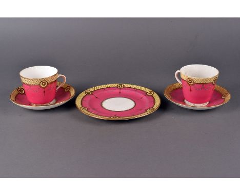 A Edwardian tea service in pink with a yellow border and applied gilt design, together with a pair of Sitzendorf  figures in 