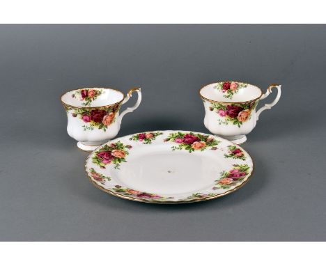 An extensive collection of Royal Albert porcelain Country Roses pattern tableware, including six dinner plates, serving dishe