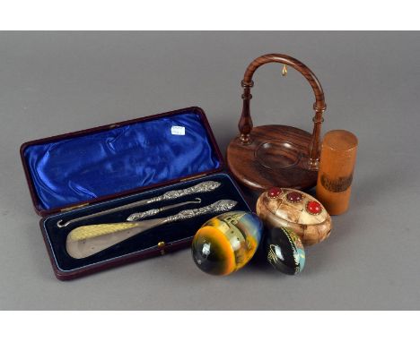 A collection of works of art, including, painted Russian wooden eggs, plated stilton scoop, a boxed ladies button hooks and s