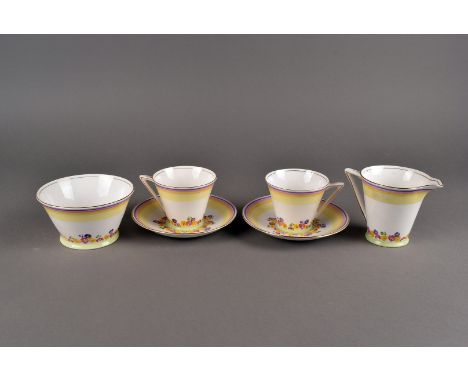 A Standard China Art Deco style part tea set, comprising thre cups and saucers, a sugar bowl and milk jug, having brightly co