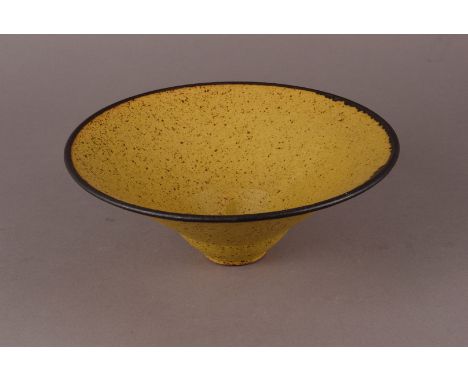 Lucie Rie (1902-1995), Circa 1960, conical form mustard yellow bowl, with subtle manganese spots and manganese rim, slightly 