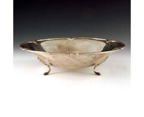 An Art Deco silver bowl, William Hair Haseler, Birmingham 1936, everted and hexalobular with open looped rim, on three geomet