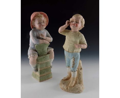 Two Gebruder Heubach bisque figures of children in spectacles, one sitting on a chair with cigarette, the other standing, 31c
