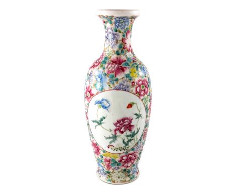 A Chinese famille rose vase, Qianlong mark, shouldered ovoid form, decorated with circular cartouches of poppies and chrysant