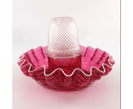 A Victorian Clarke's fairy lamp, clear moulded shade on cranberry ruffle base with white trailed border, 24cm diameter