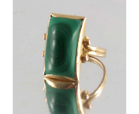 A malachite cabochon single-stone ring, with openwork shoulders, stamped 18ct, ring size P1/2, 8.1g