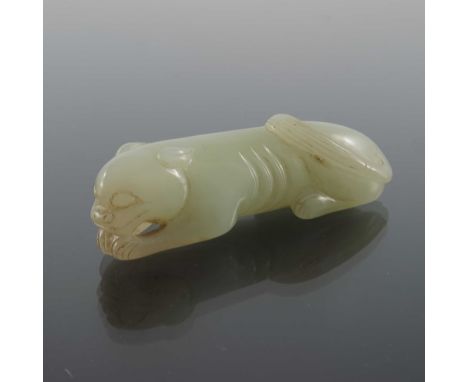 A Chinese jade carving of a lion, modelled in relief, recumbent, 7cm long
