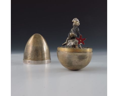 Stuart Devlin, a novelty silver gilt surprise egg, London 1974, the brushed body with plain band opening to reveal a leprecha