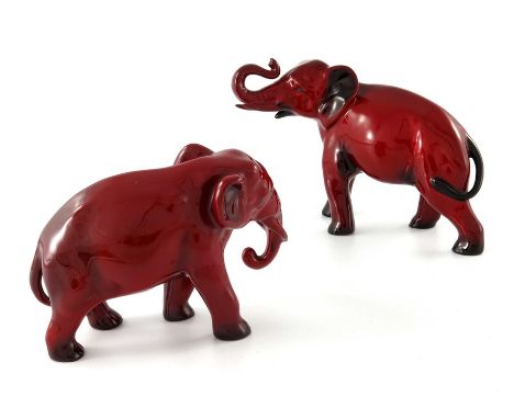 Charles Noke for Royal Doulton, two Flambe Elephant figures, one modelled with trunk raised, the other with trunk down, 24cm 