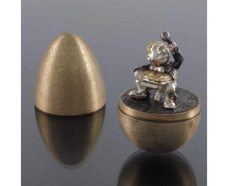 Stuart Devlin, a novelty silver gilt surprise egg, London 1973, the horizontally brush textured body opening to reveal a seat