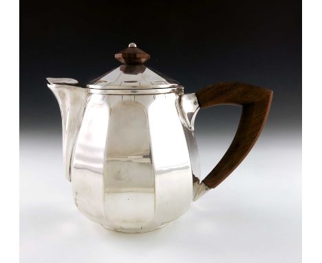 A French Art Deco silver plated teapot, Phenix, Lyon circa 1925, multifaceted ovoid form with walnut handle and finial, the s