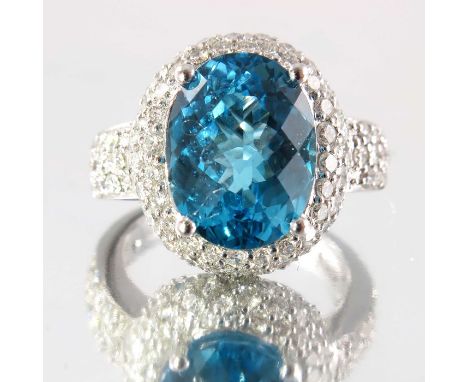 An 18ct gold blue topaz and diamond cocktail ring, topaz weight 7.33cts, engraved to band, estimated total diamond weight 1.6