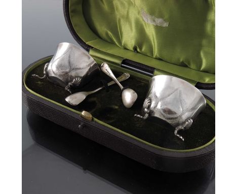 A pair of Arts and Crafts silver salt cellars and spoons, William Hair Haseler, Birmingham 1904, ogee bowls embossed and plan