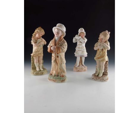 Four Gebruder Heubach bisque child figures, two modelled as girls holding birds, another as a boy in his father's clothes and