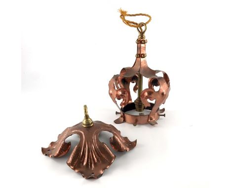 An Arts and Crafts copper pendant light fitting, the crown form shade cage with lobed and  foliated straps, suspended from a 
